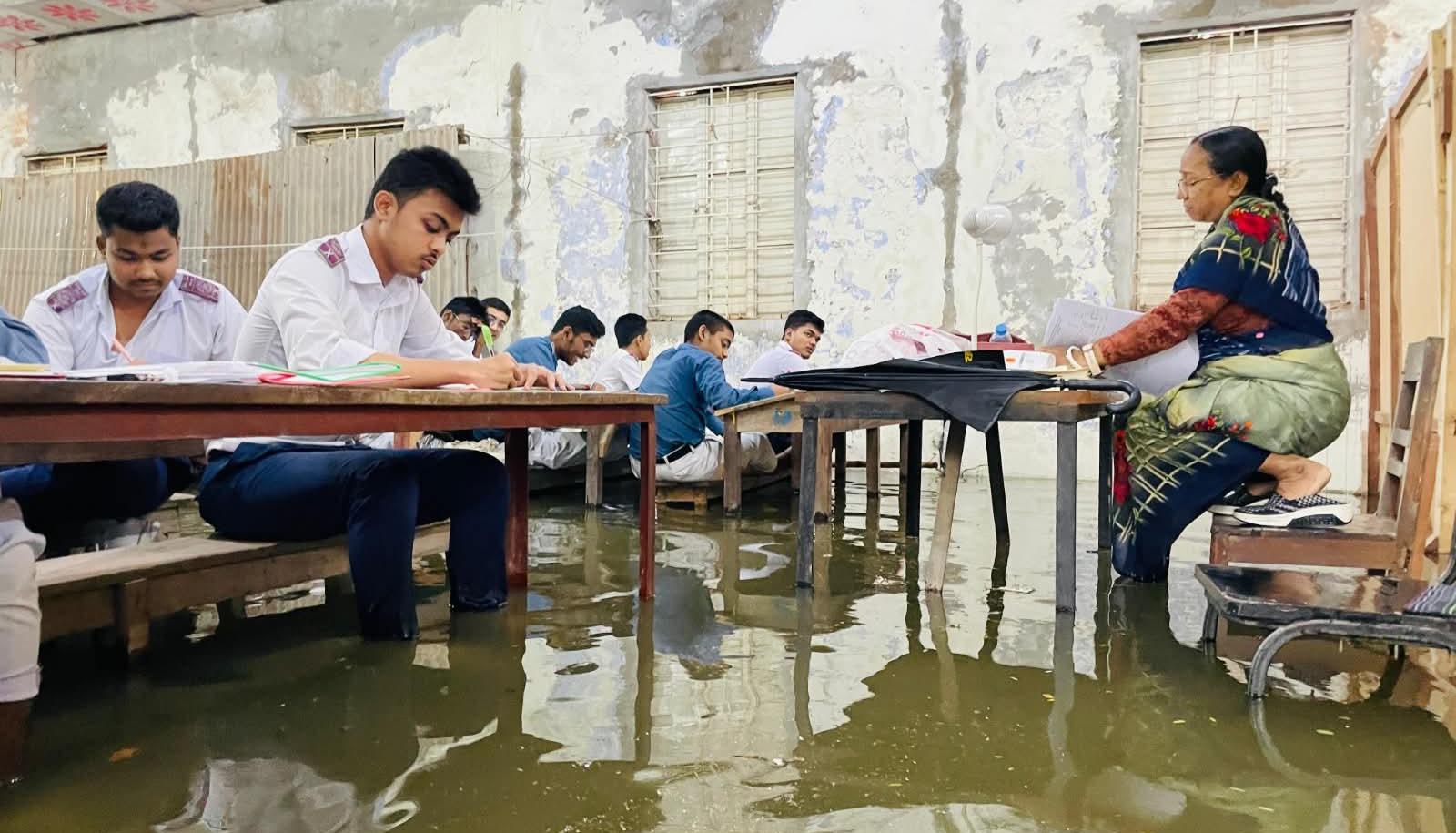 কুমিল্লায় জলাবদ্ধতার মধ্যে এসএসসি পরীক্ষা, বেঞ্চে পা তুলে পরীক্ষা দিলেন শিক্ষার্থীরা